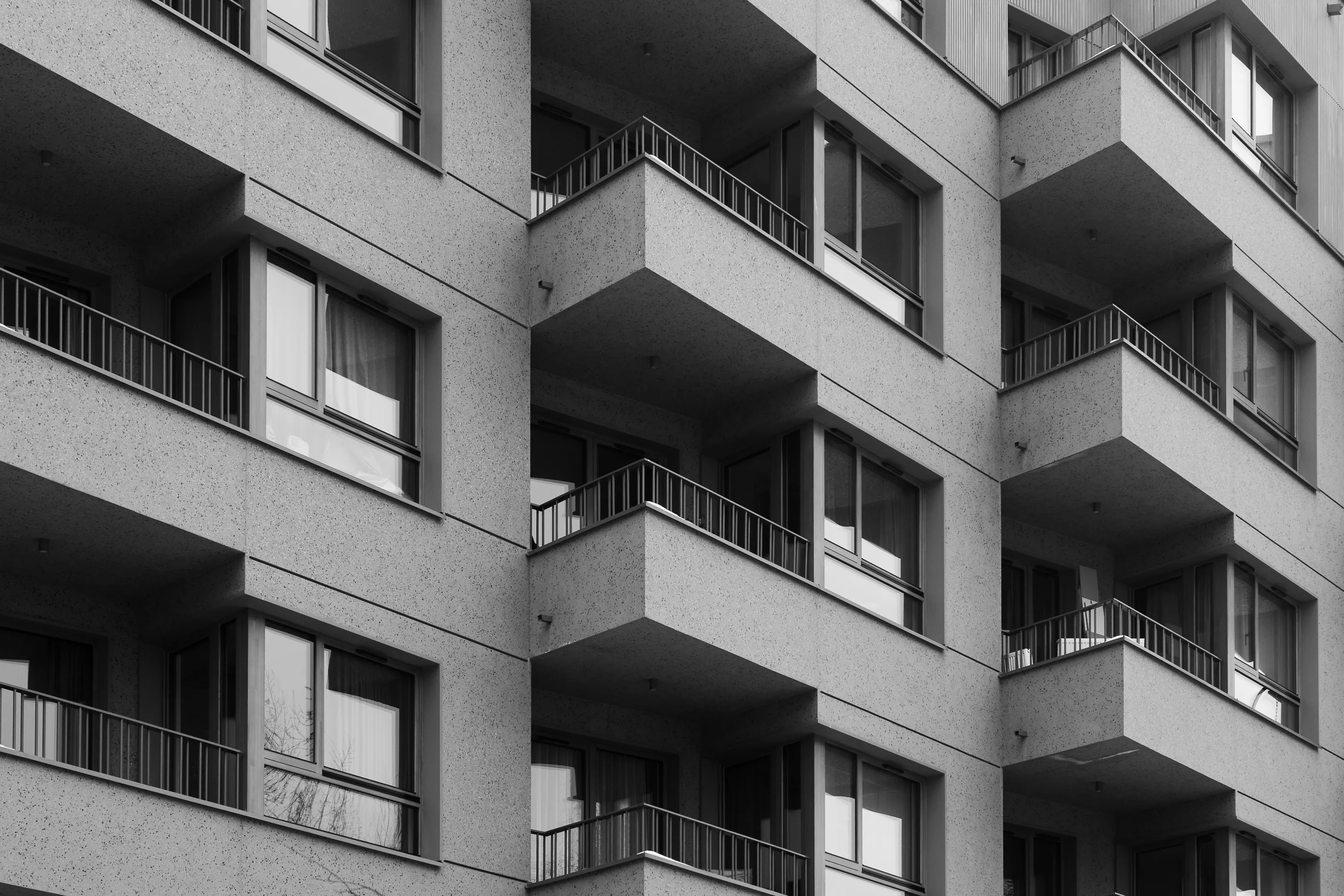 Black-and-white study of a housing block's zigzagging cantilevered balconies.